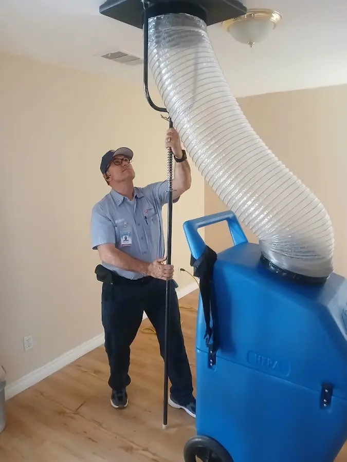 Furnace Tune-Up technician using HEPA equipment in Pecan Plantation